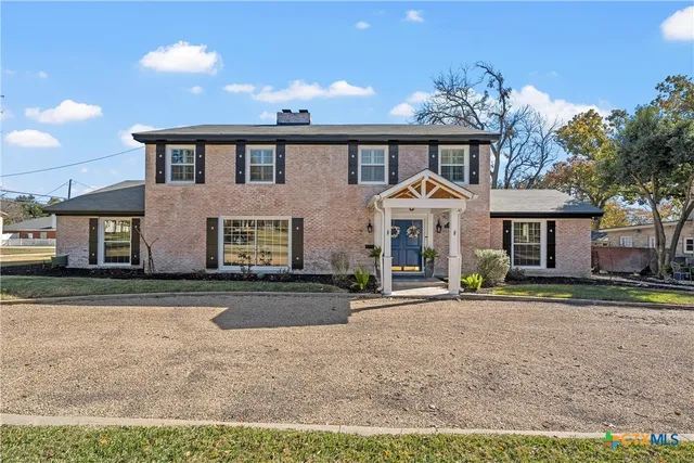 a front view of a house with a yard and a garage