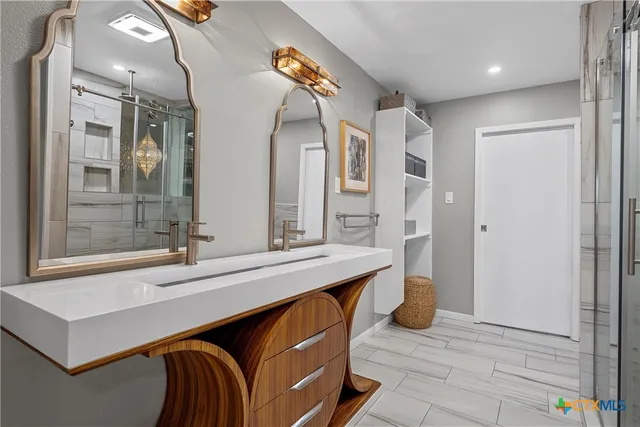 a bathroom with a sink double vanity and a mirror