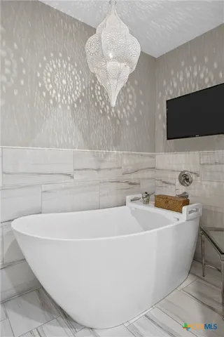 a white bath tub sitting in a bathroom