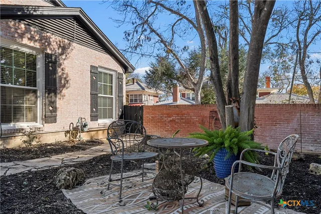 a view of backyard of house with seating space