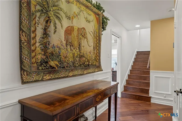 a view of a dinning room with wooden floor and stairs
