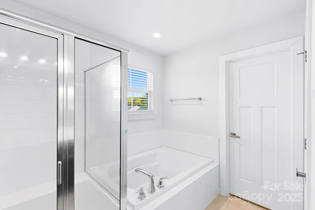 a bathroom with a tub and shower