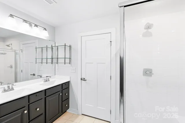 a bathroom with a double vanity sink a and mirror