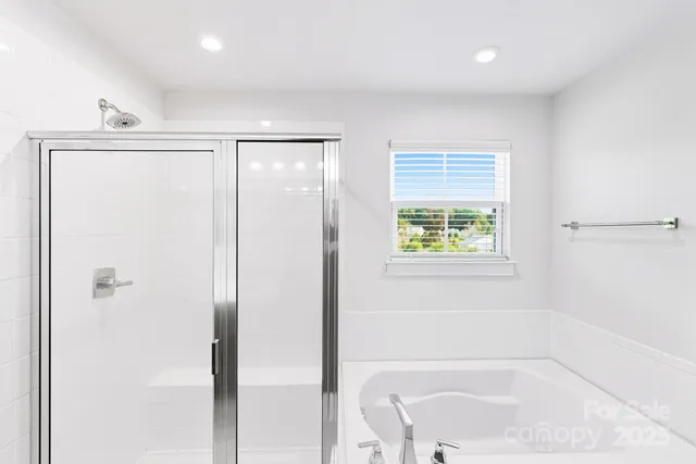 a bathroom with a bathtub and shower