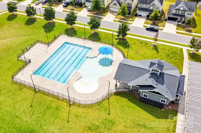 an aerial view of a swimming pool with a patio
