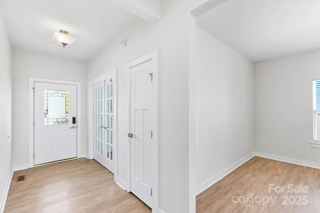 a view of a hallway with wooden floor