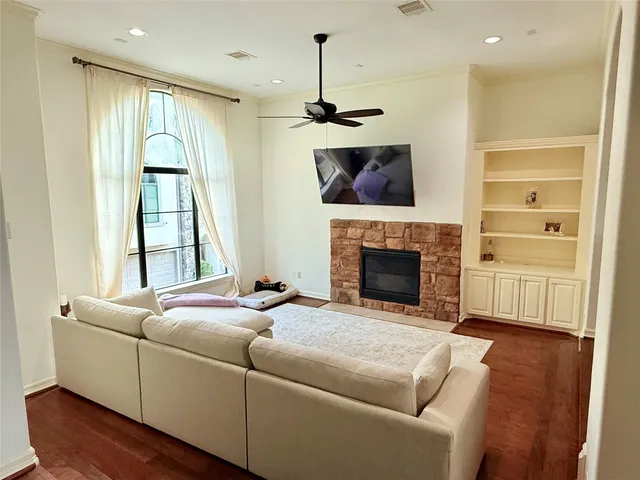 a living room with furniture a window and a fireplace