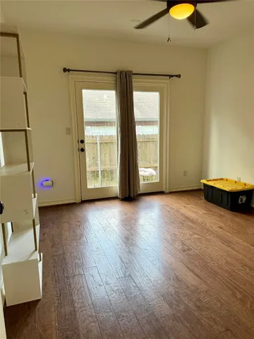 a view of room with window and wooden floor