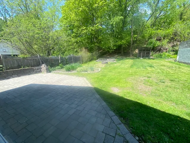 a backyard of a house with trampoline