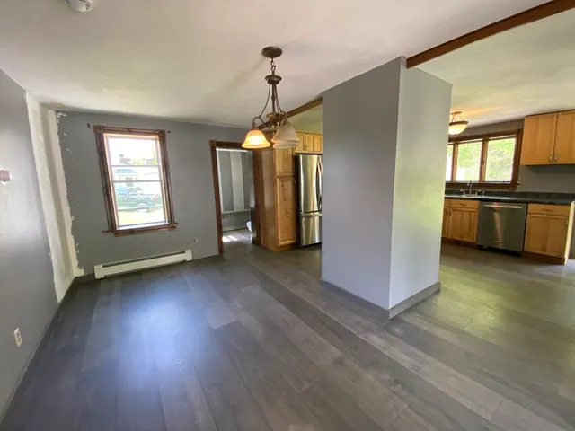 a view of a room with wooden floor and staircase