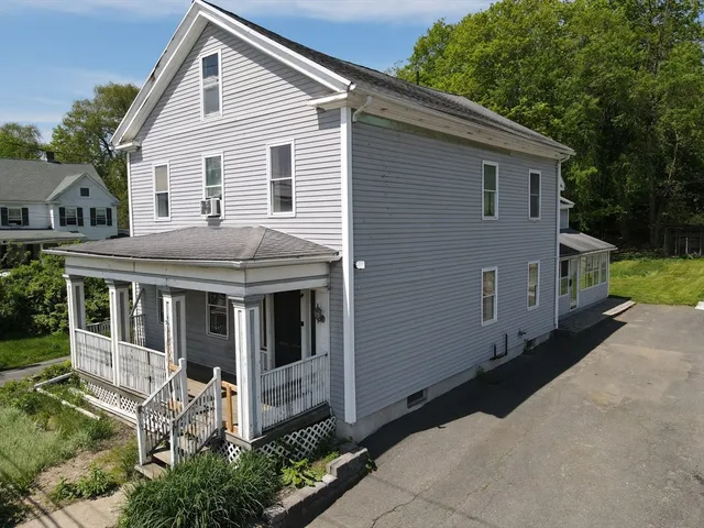 an aerial view of a house with a yard