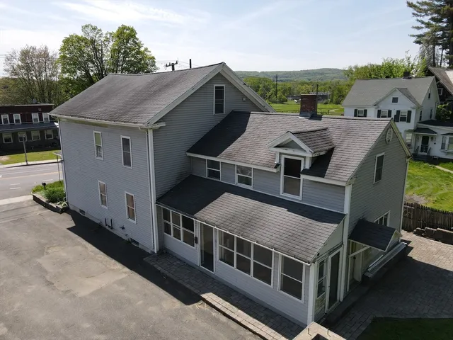 an aerial view of a house with a yard