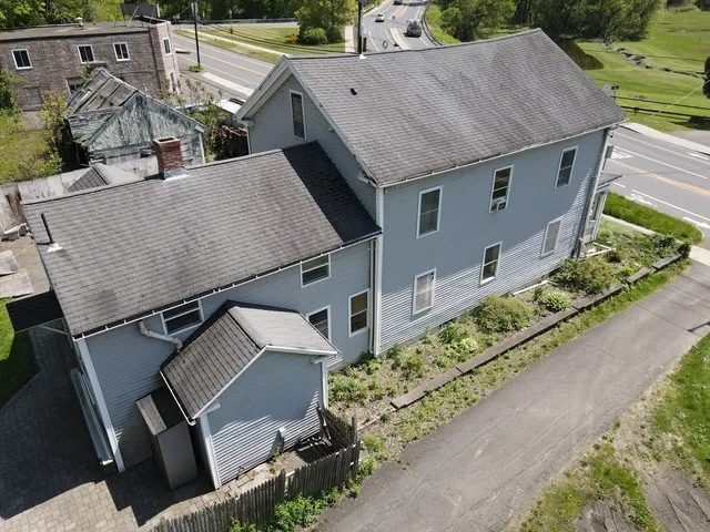 an aerial view of a house with a yard