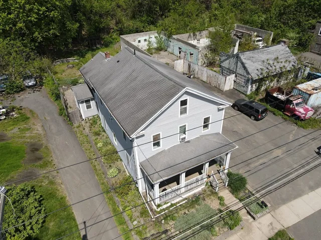 an aerial view of a house with a big yard
