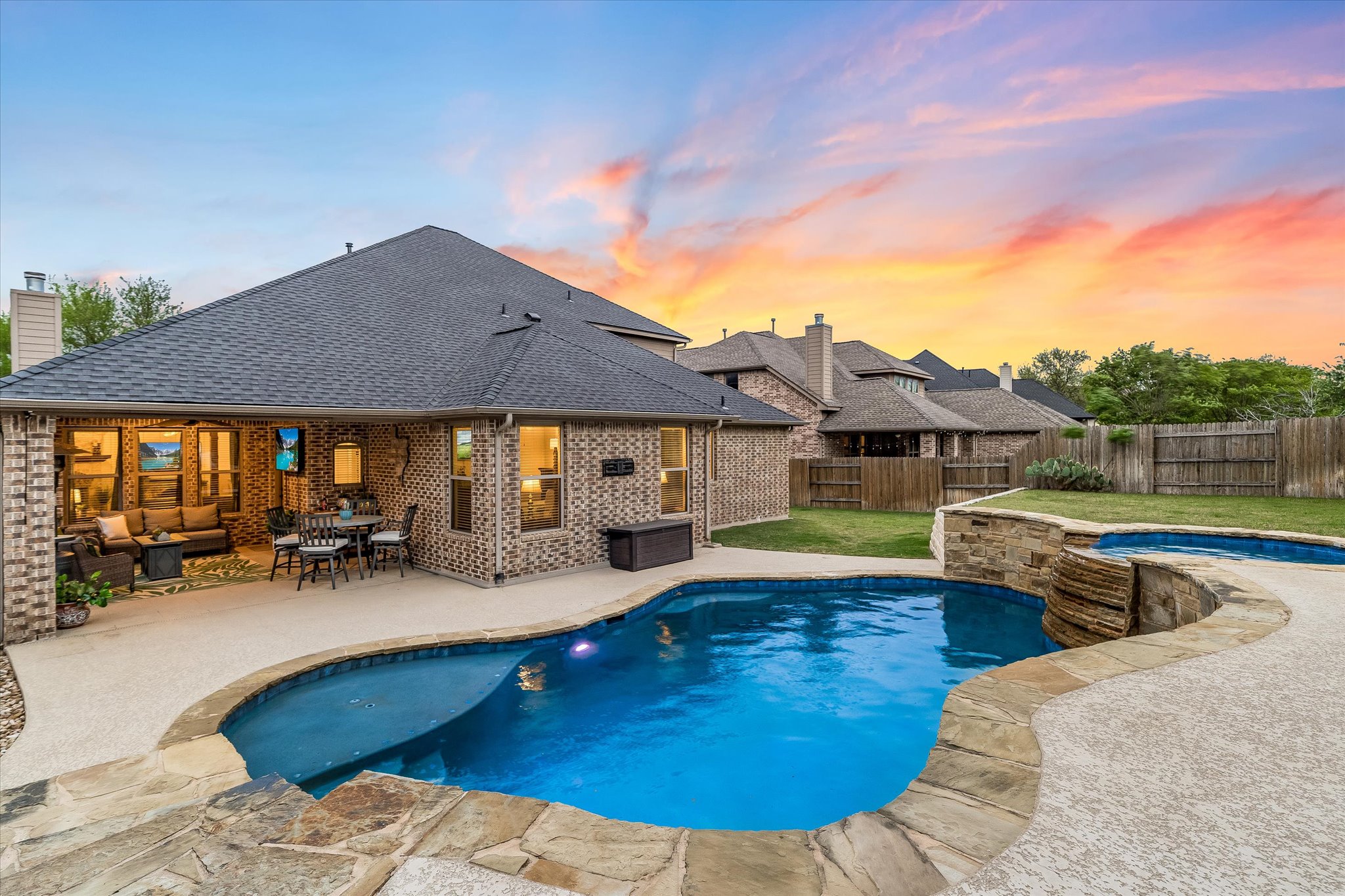 226 Galloway Lane Austin, TX 78737 - Photo 2 of 30 Integrated pool / spa with a patio, a fenced backyard, and an outdoor living / dining area