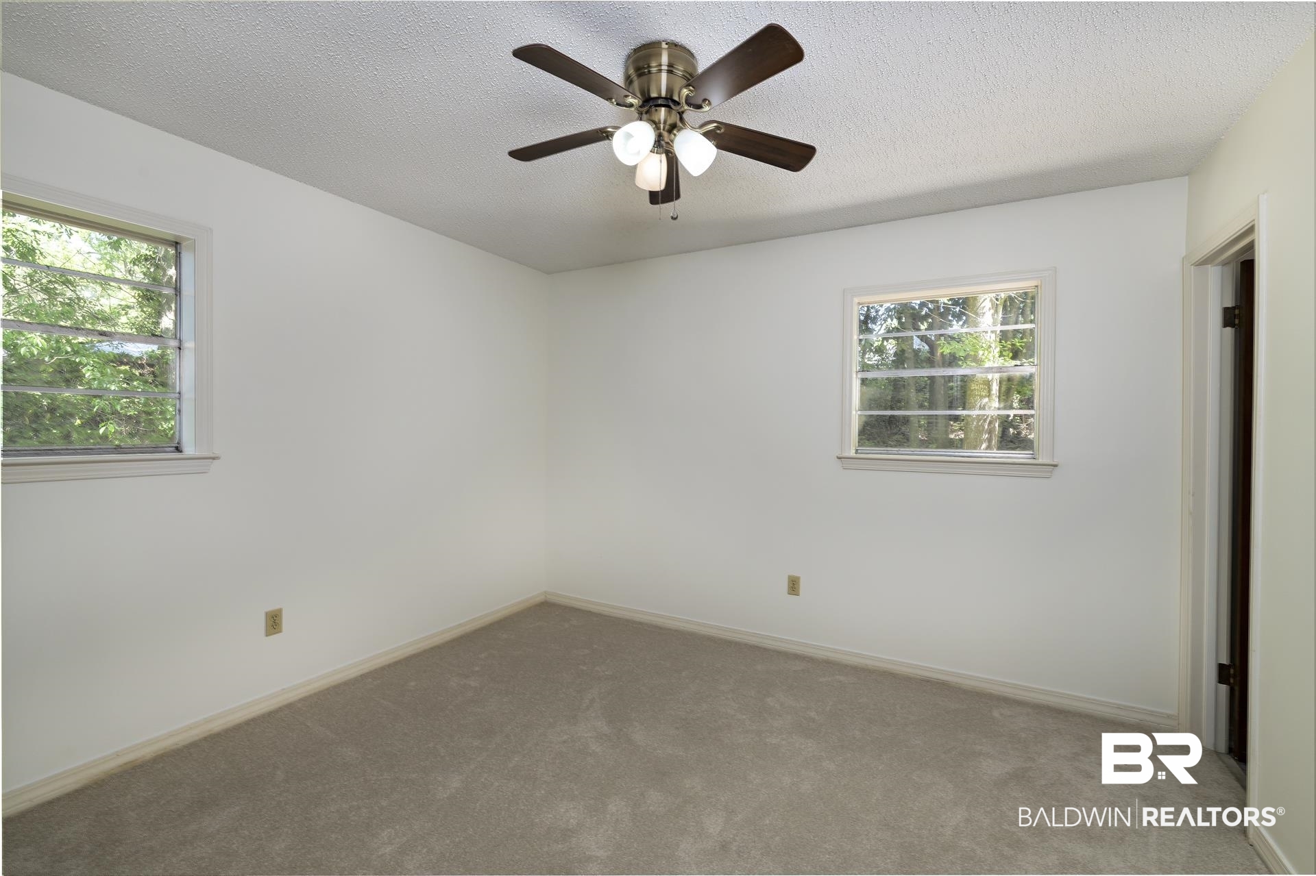 707 Johnson Avenue Fairhope, AL 36532 - Photo 33 of 38 Empty room featuring a textured ceiling, ceiling fan, plenty of natural light, and carpet floors