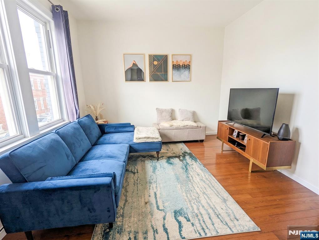 582 60th Street West New York, NJ 07093 - Photo 2 of 10 a living room with furniture and a flat screen tv