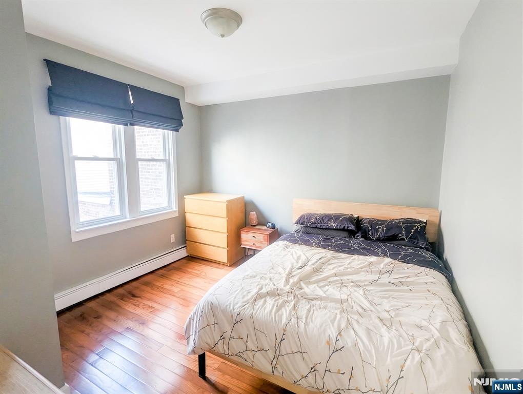 582 60th Street West New York, NJ 07093 - Photo 6 of 10 a bedroom with a bed and window