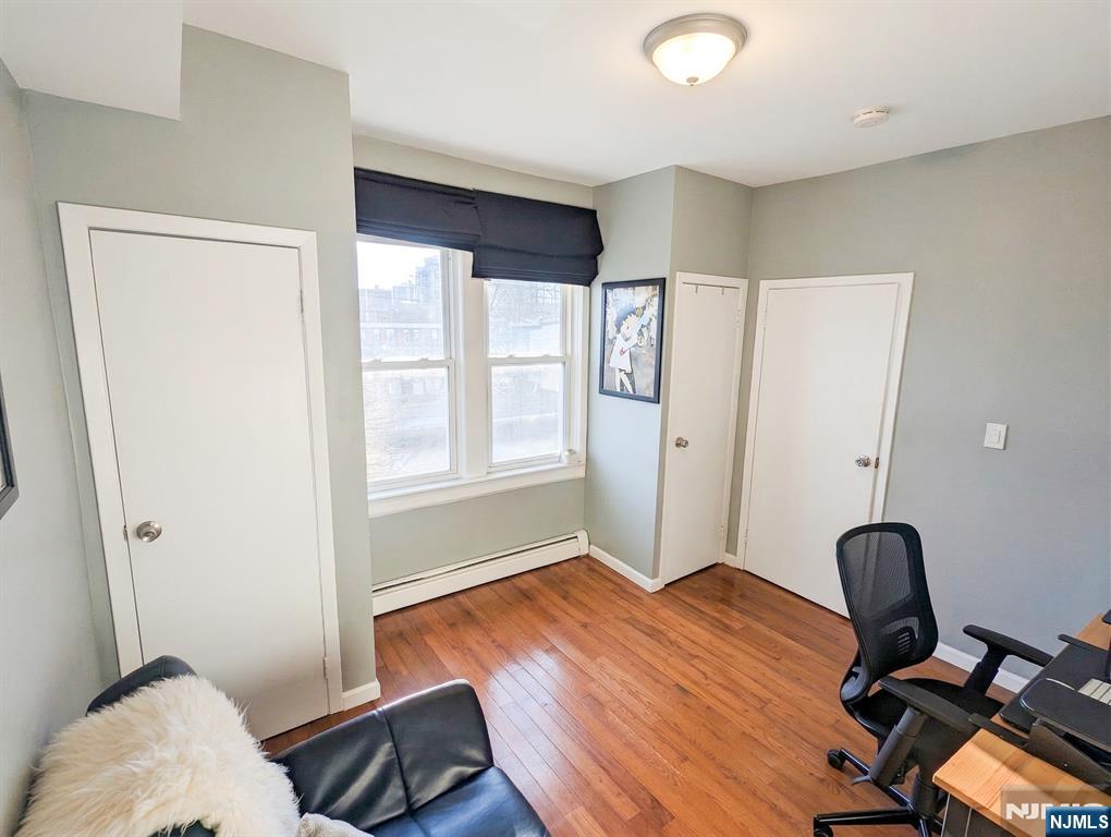582 60th Street West New York, NJ 07093 - Photo 9 of 10 a bedroom with a bed and wooden floor
