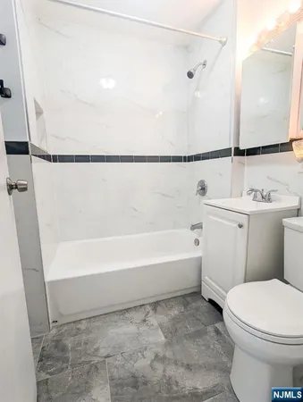 a bathroom with a toilet a sink and bathtub