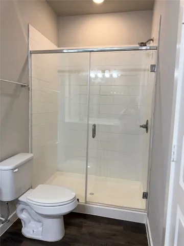 a bathroom with a shower and a toilet