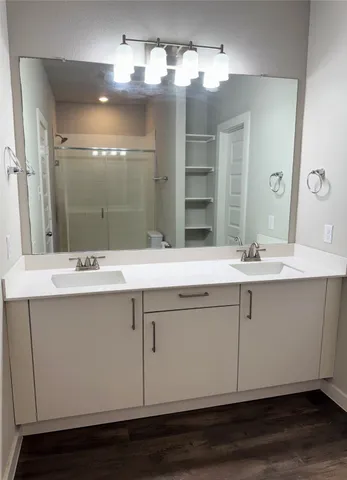 a bathroom with a sink double vanity and a mirror