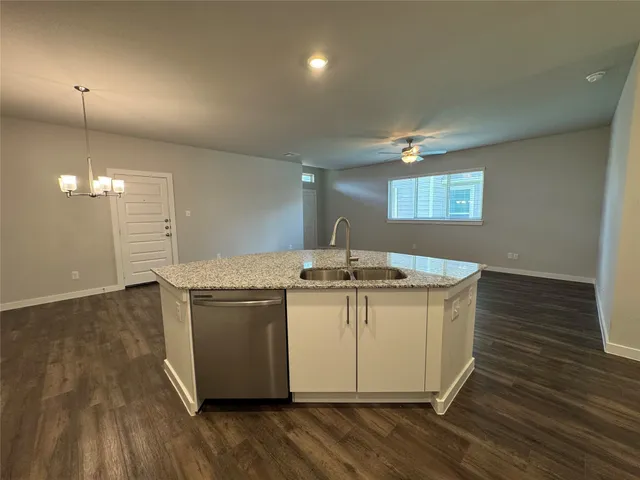 a view of a kitchen with a sink and wooden floor