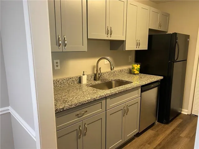 a kitchen with stainless steel appliances granite countertop a refrigerator sink and cabinets