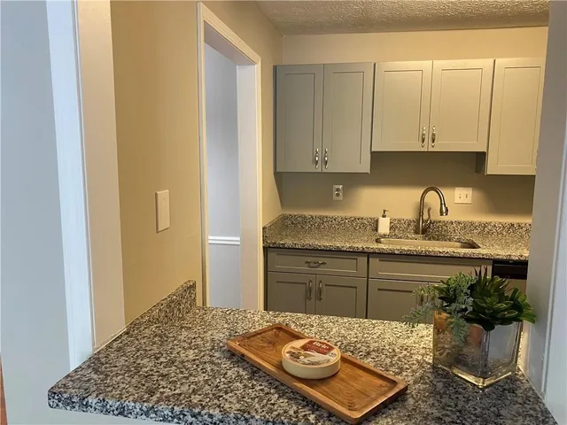 a kitchen with a sink and cabinets