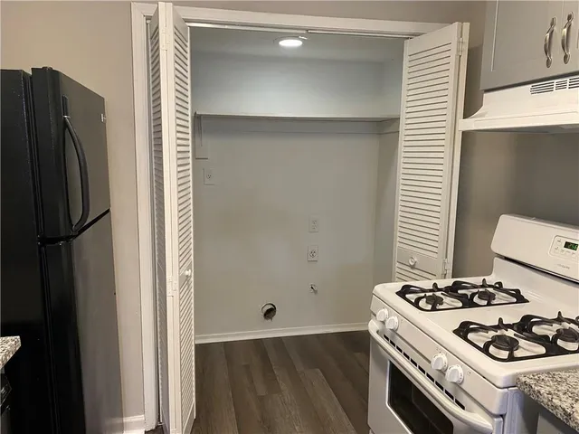 a kitchen with a stove and a refrigerator