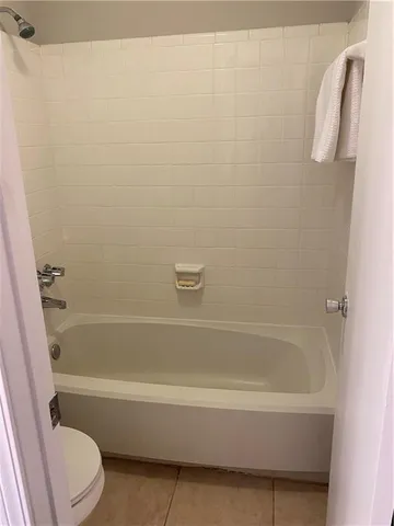 a bathroom with a bathtub and a toilet