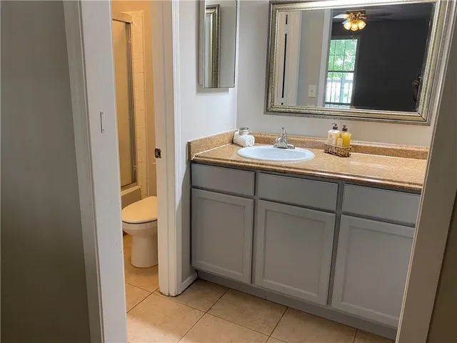 a bathroom with a sink toilet and mirror