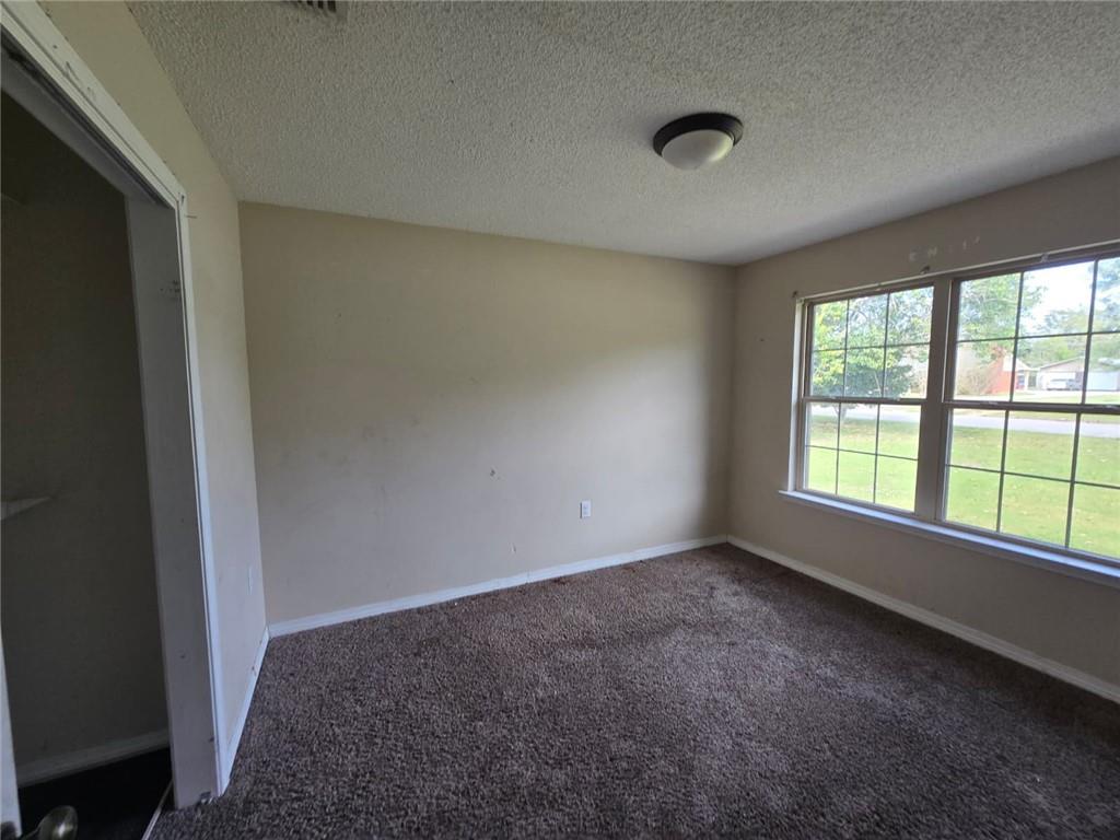 141 McRae Street Atmore, AL 36502 - Photo 11 of 25 a view of an empty room with a window