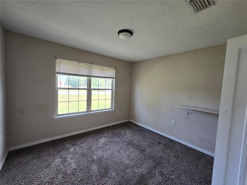141 McRae Street Atmore, AL 36502 - Photo 13 of 25 a view of an empty room with a window