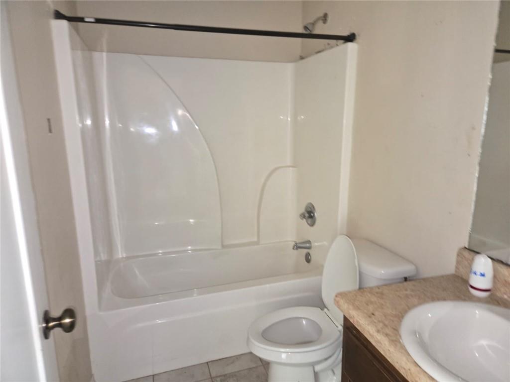 141 McRae Street Atmore, AL 36502 - Photo 14 of 25 a bathroom with a granite countertop sink toilet and shower
