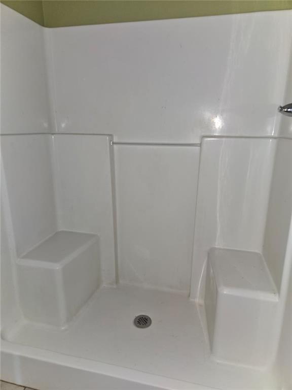 141 McRae Street Atmore, AL 36502 - Photo 20 of 25 a bathroom with a shower and a bathtub