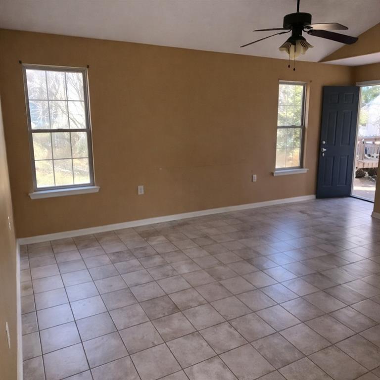 141 McRae Street Atmore, AL 36502 - Photo 2 of 25 an empty room with windows and chandelier fan