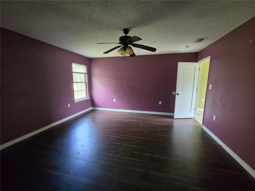 141 McRae Street Atmore, AL 36502 - Photo 21 of 25 a view of a livingroom with wooden floor and a ceiling fan