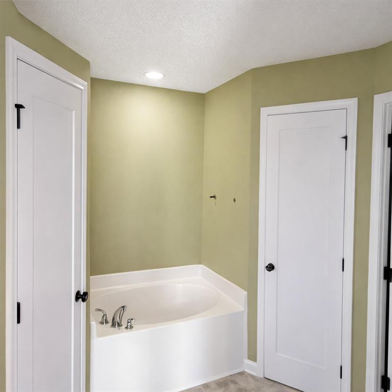 141 McRae Street Atmore, AL 36502 - Photo 6 of 25 a bathroom with a bathtub