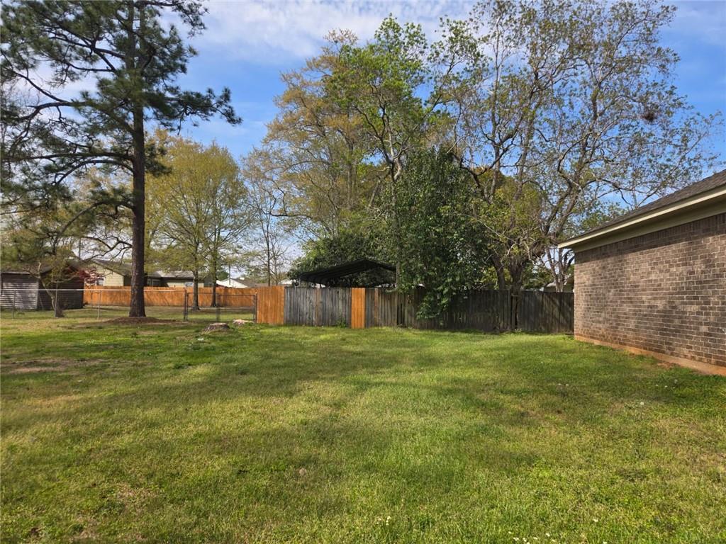 141 McRae Street Atmore, AL 36502 - Photo 9 of 25 a big yard with lots of green space and trees