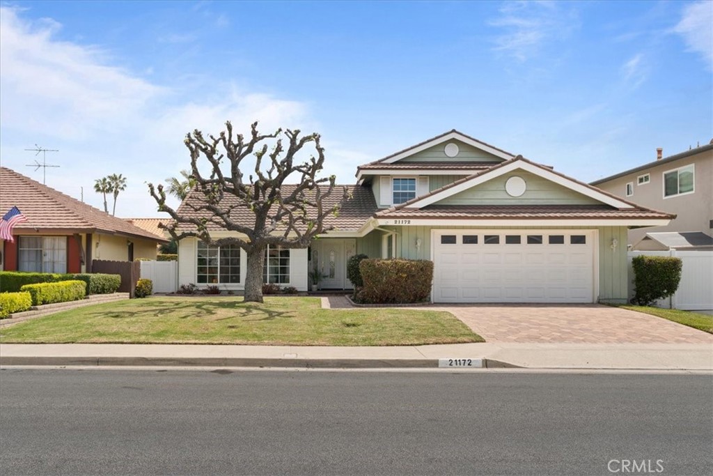 a house that has a tree in front of it