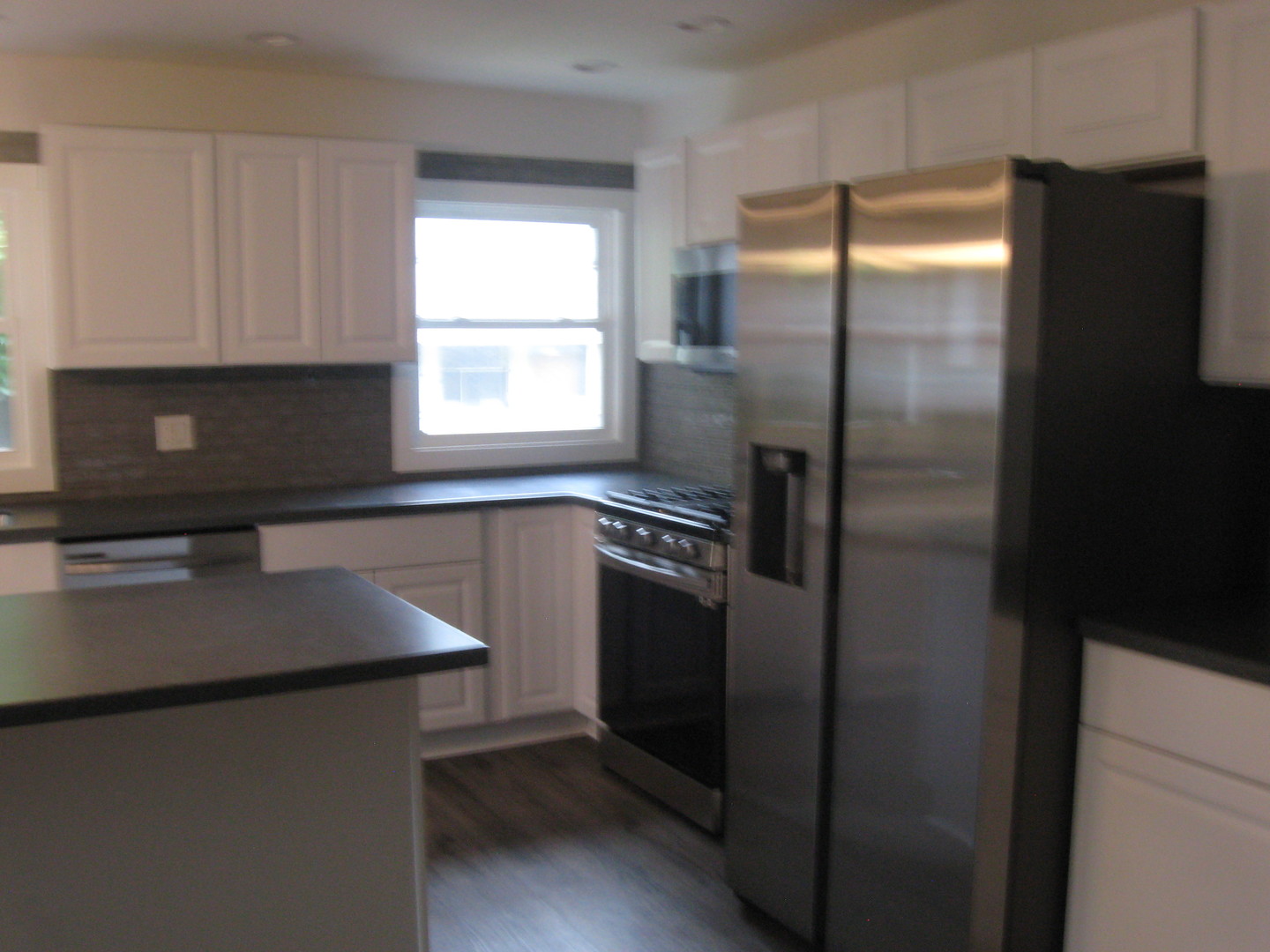 113 West 3rd Street Spring Valley, IL 61362 - Photo 3 of 12 a kitchen with a refrigerator and a sink