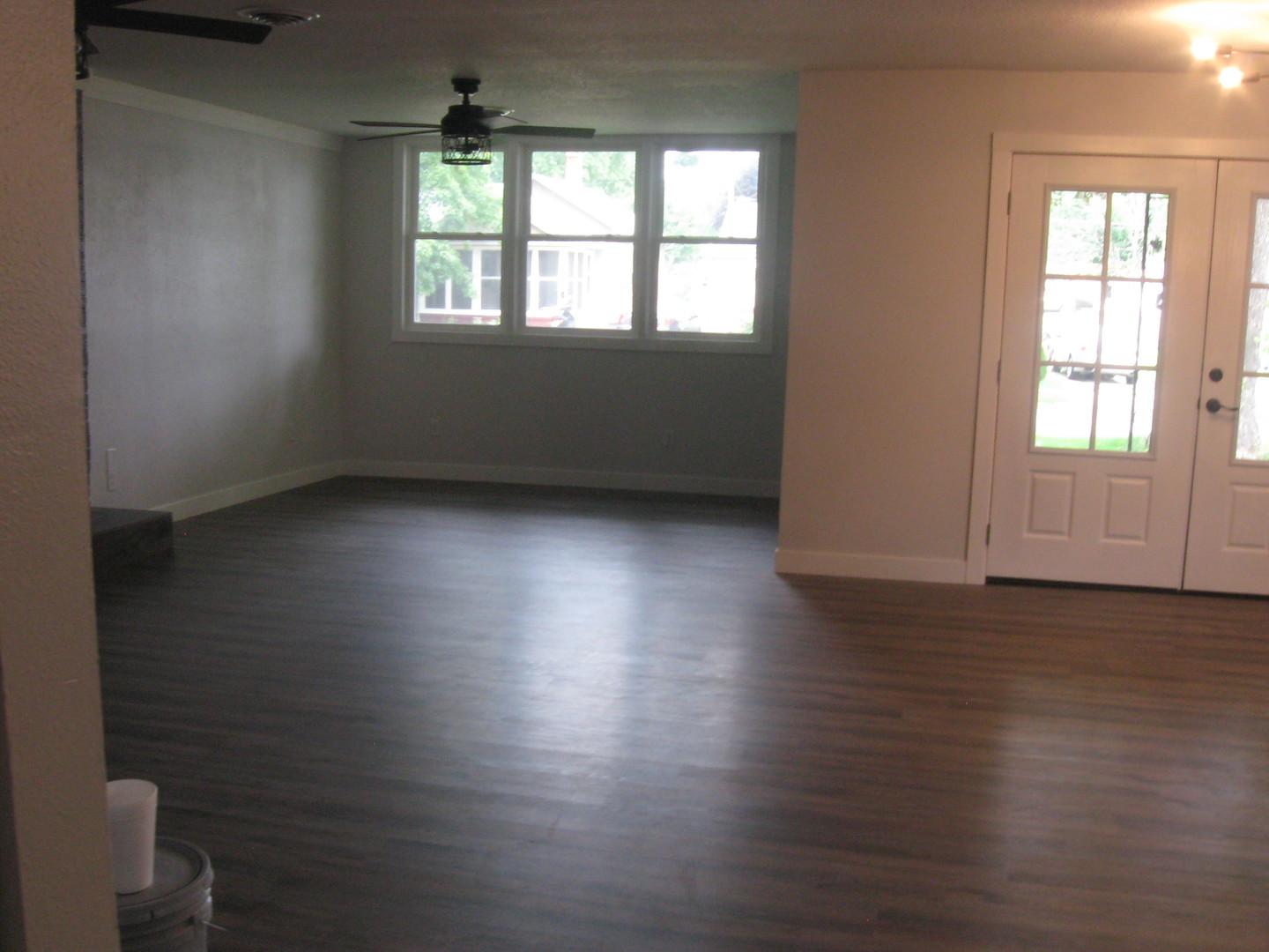 113 West 3rd Street Spring Valley, IL 61362 - Photo 5 of 12 an empty room with wooden floor and windows