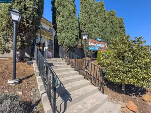 a view of a patio with iron fence