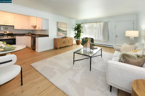 a living room with furniture and a kitchen