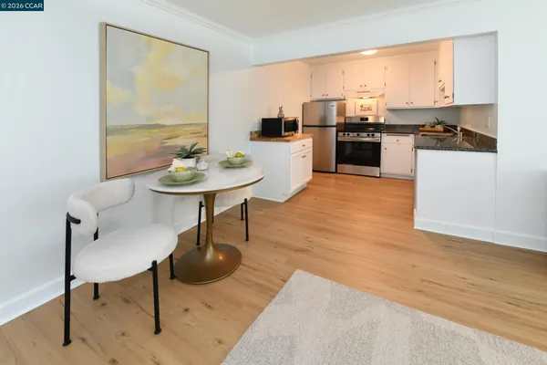 a living room with stainless steel appliances kitchen island granite countertop furniture and a kitchen view