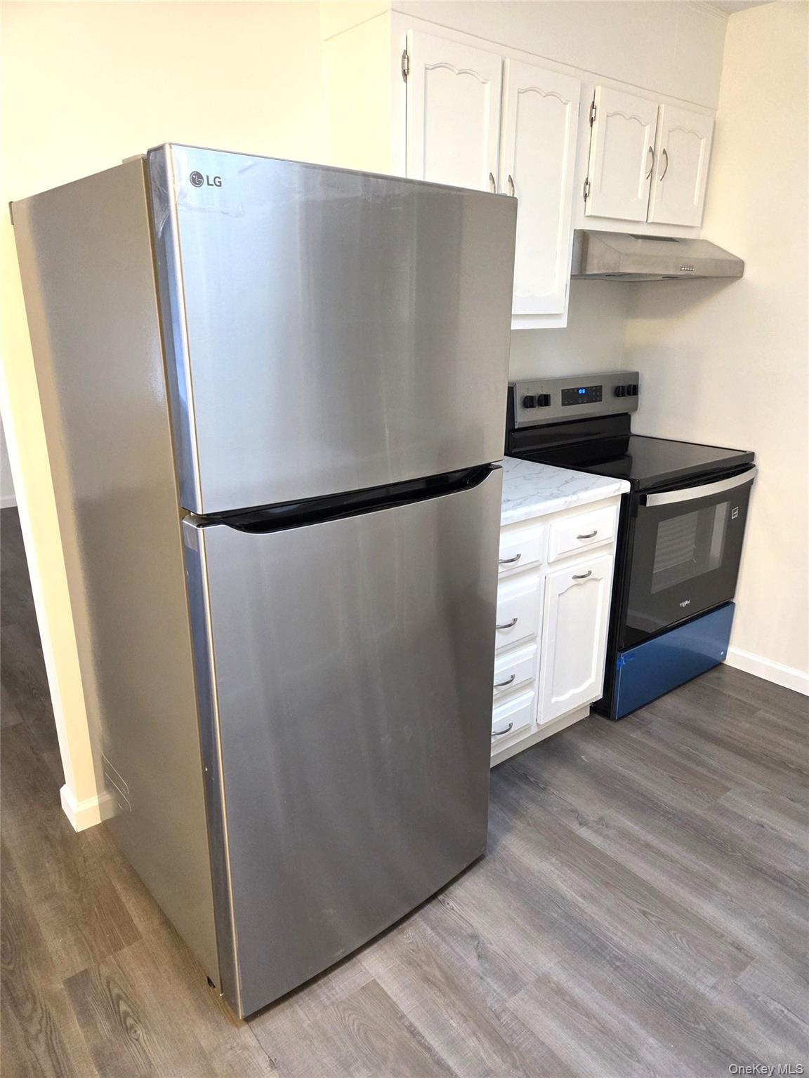 186 C Ventry Court Ridge, NY 11961 - Photo 11 of 25 a white refrigerator freezer sitting in a kitchen