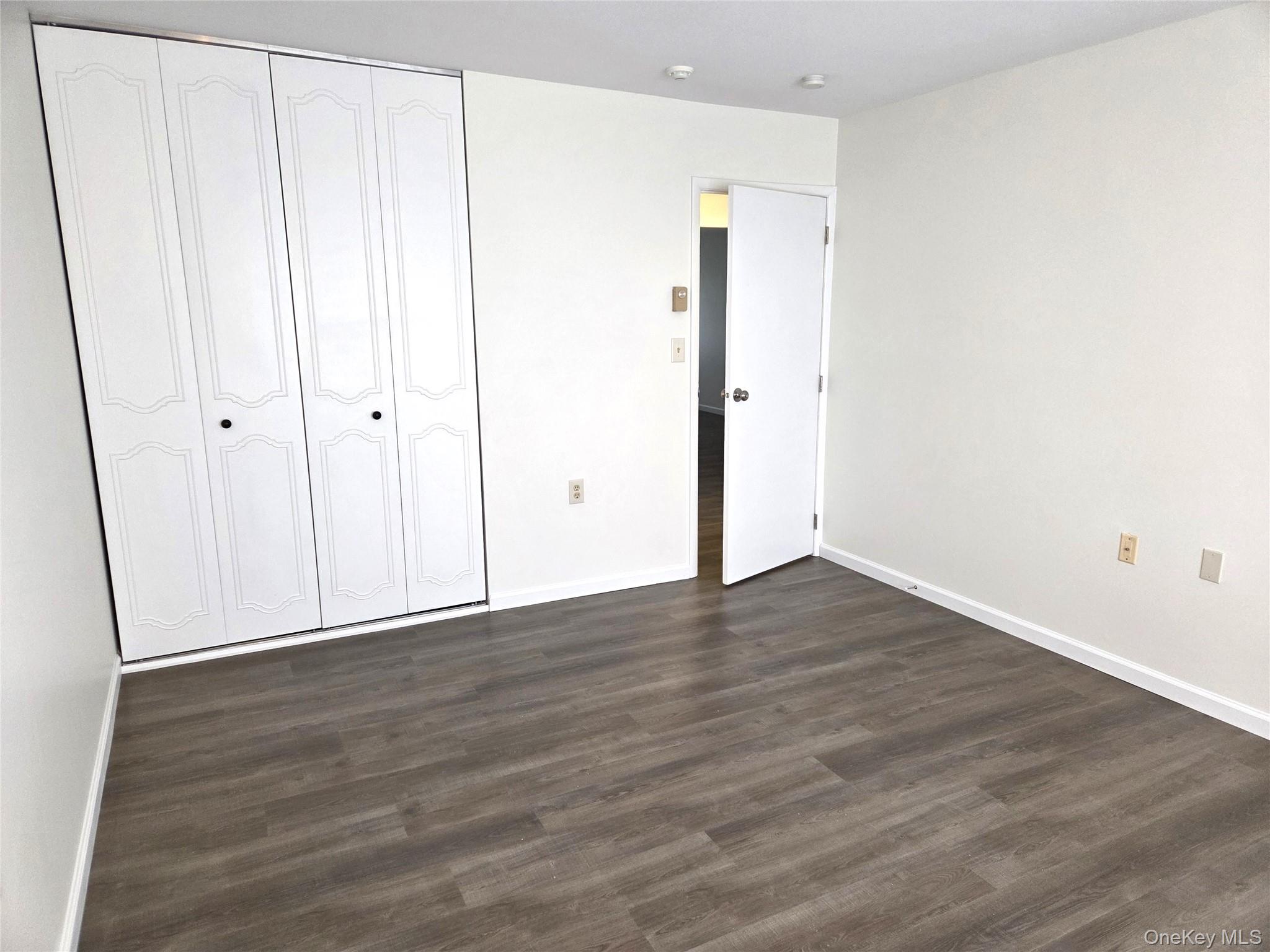 186 C Ventry Court Ridge, NY 11961 - Photo 15 of 25 a view of an empty room with wooden floor