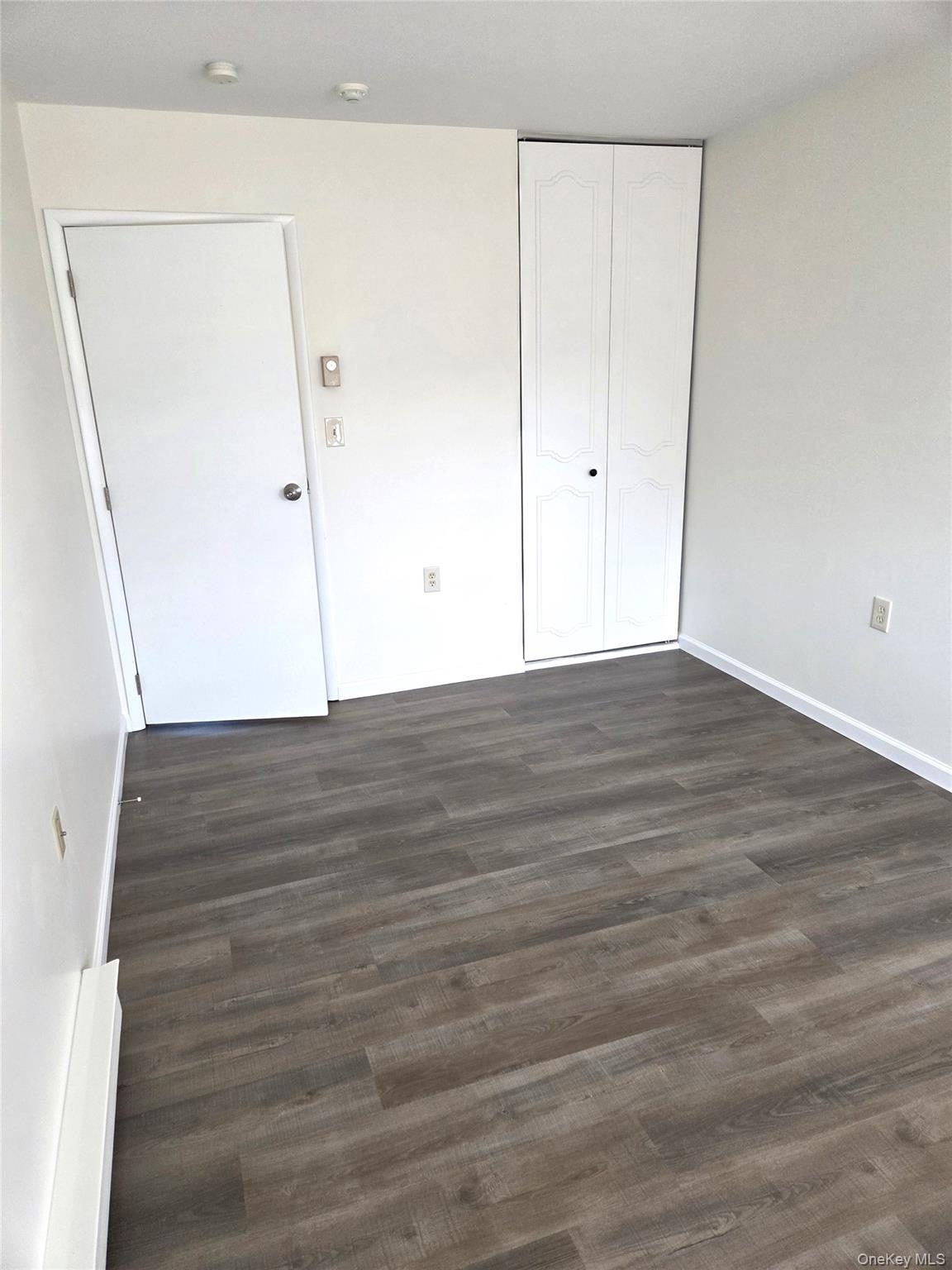 186 C Ventry Court Ridge, NY 11961 - Photo 16 of 25 The Guest/Second Bedroom Offers Ample Room For Furniture, All New Luxury Vinyl Plank Flooring & A Good Sized Closet.