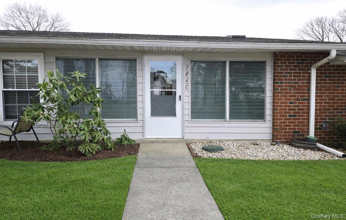 186 C Ventry Court Ridge, NY 11961 - Photo 2 of 25 a front view of a house with a garden